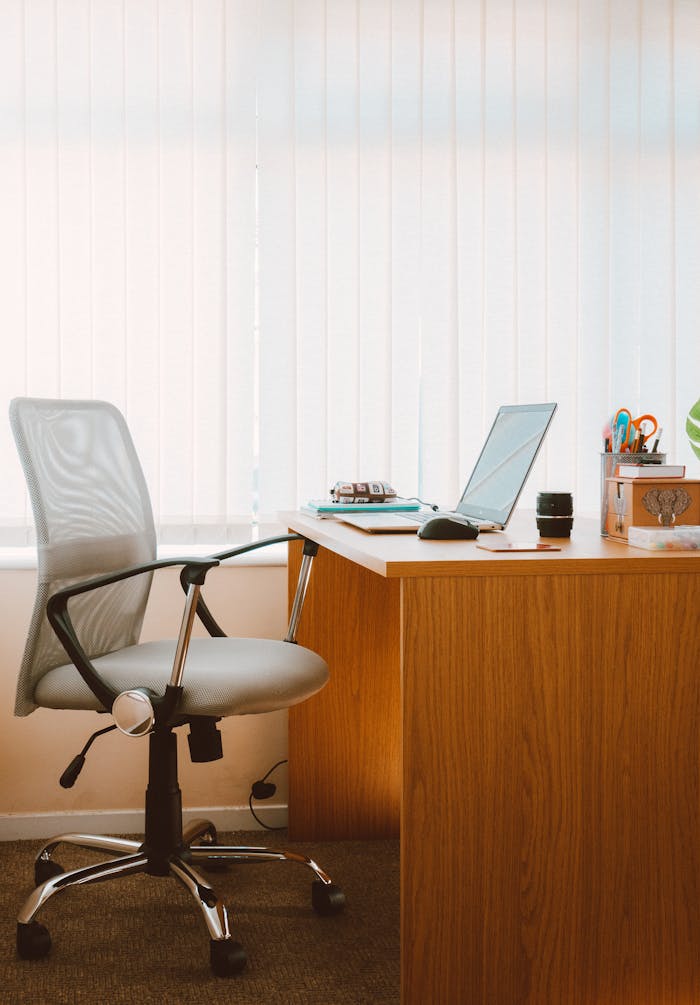 pexels photo 1957477 A tranquil modern home office featuring a wooden desk, ergonomic chair, and soft natural light.