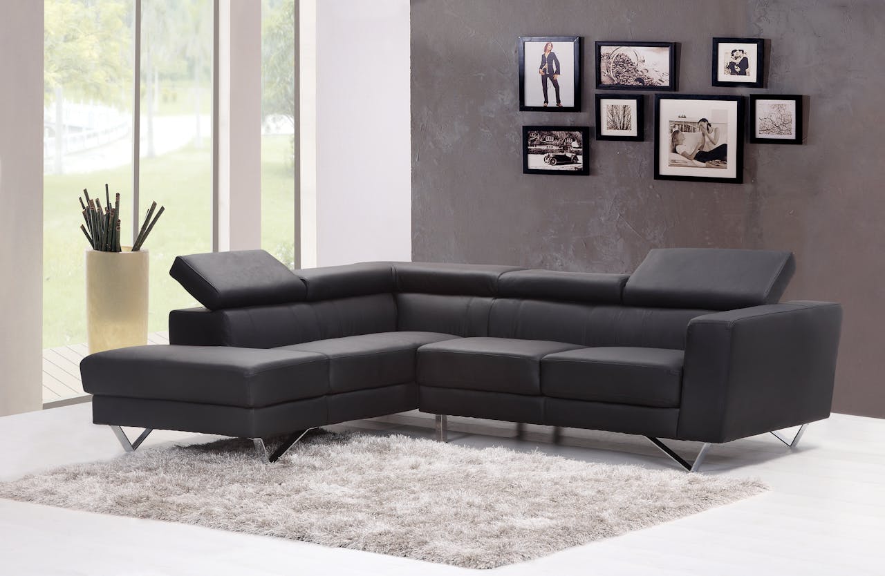 pexels photo 276583 Contemporary living room featuring a sleek black sectional sofa and chic wall art.